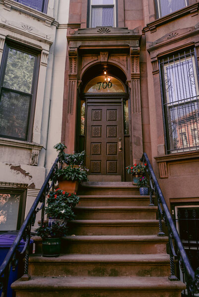 Brownstone house in New York. Typical exterior steps and doors on residential homes in the Chelsea district and Brooklyn in New York City
