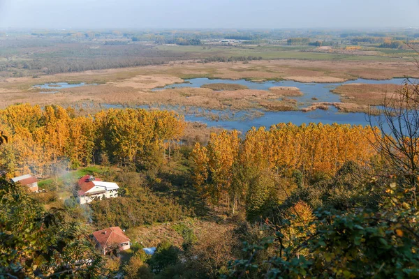 Küçük köy ve gölü olan sonbahar manzarası.