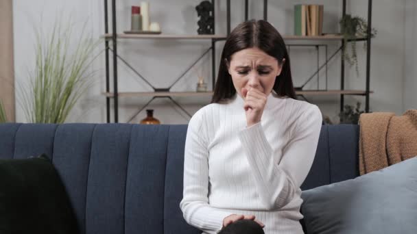 Young woman coughing on the couch. Close up of sick girl cough cold. — Stock Video