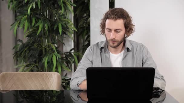 Сфокусированный бизнесмен, работающий на ноутбуке в домашнем офисе. — стоковое видео