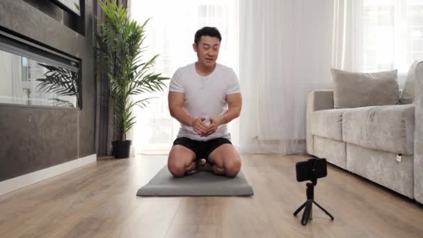 Osobní asijské trenér video blogování nahrávání online cvičení na mobilním telefonu. — Stock video