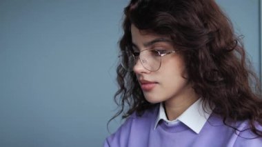 Uzaktan kumandalı dizüstü bilgisayarda yazan güzel bayan serbest yazar ya da internetten sosyal mesafe öğrenen, gözlüklü güzel profesyonel tasarımcı kız bilgisayar teknolojisi kullanarak ofiste online iş yapıyor..