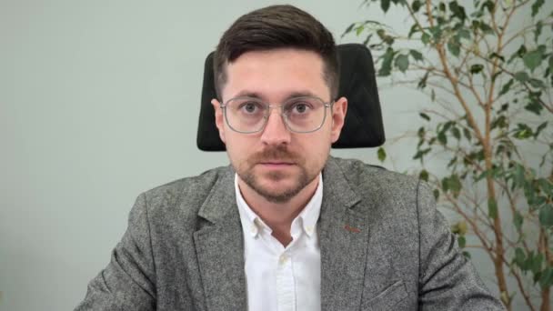 Handsome businessman office worker in glasses having video call with leader company meeting online listening to speaker agreeing nodding head looking to camera web cam view. Internet communication. — Wideo stockowe