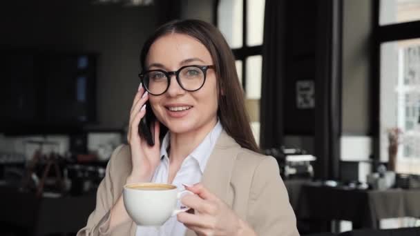 Stylowa Kobieta Biznesu Okularach Mając Telefon Komórkowy Podczas Picia Kawy — Wideo stockowe