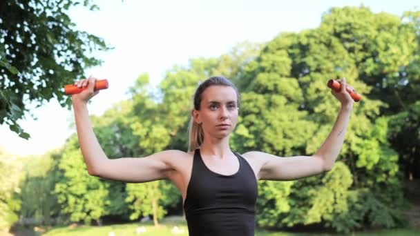 Attractive Female Lifting Dumbbells Breathing Training Shoulders Sunset Green City — Stock videók