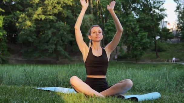 Adorable Woman Practices Yoga Meditates Lotus Position City Park Green — Αρχείο Βίντεο