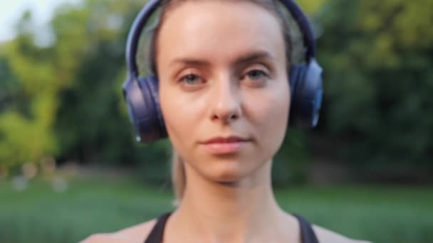 Beautiful Dreamful Positive Pretty Female Athlete Takes Headphones Listening Music — Video Stock