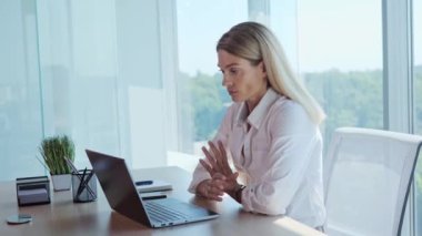 Pensive thoughtful businesswoman working on laptop having idea typing on keyboard. Portrait of smiling female concentrated employee . Dreamy business woman thinking in office. Lady looking away