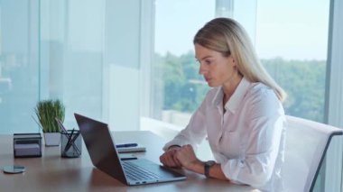 Confident focused entrepreneur female leader on online video call, listening to his partners, nodding agree working from office. Remote worker on laptop conference communication internet web view