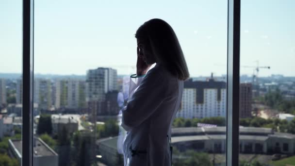 Silhouette Doctor Standing Hospital Panoramic Window Having Headache Side View — Vídeo de Stock