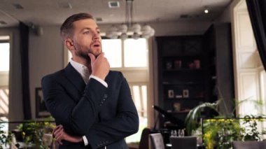 Attractive businessman looking ahead closeup. Confident professional resting waiting thinking. Serious handsome boss having break at work. Leader person enjoy vacation and relaxing in restaurant