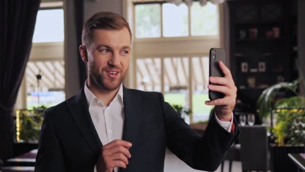 Close Joyful Young Business Man Smiling Waving Hand Looking Mobile — Stock video