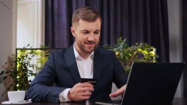 Rich businessman use smartphone and plastic credit bank card, browsing internet say wow yes, found out great big win, success lotter, good news, purchases online shopping. Positive man in restaurant