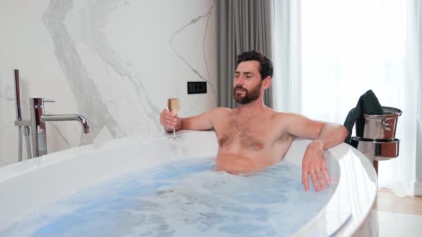 Handsome Young Strong Man Drinks Champagne Glass Sitting Large Bathtub — Wideo stockowe