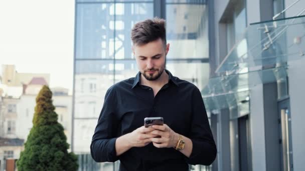 Young Businessman Walking Modern Glass Building Looking Smartphone Screen Messaging — Stock Video
