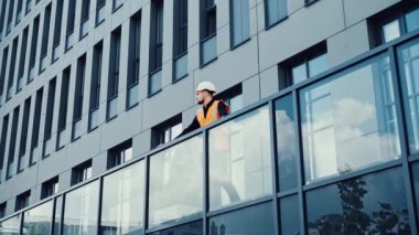 Yeni inşa edilen ofisin terasında duran yetenekli yaratıcı mimar tasarımcısı.