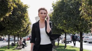 Modaya uygun güzel bir kadın sokakta yürürken akıllı telefondan konuşuyor. Büyüleyici bir iş kadını dışarı fırlıyor ve cep telefonuyla konuşuyor. Cep telefonuyla konuşan kadın rüzgarı esiyor.