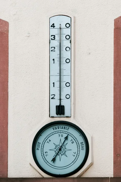 Temperature gauge and barometer on a wall in Strasbourg