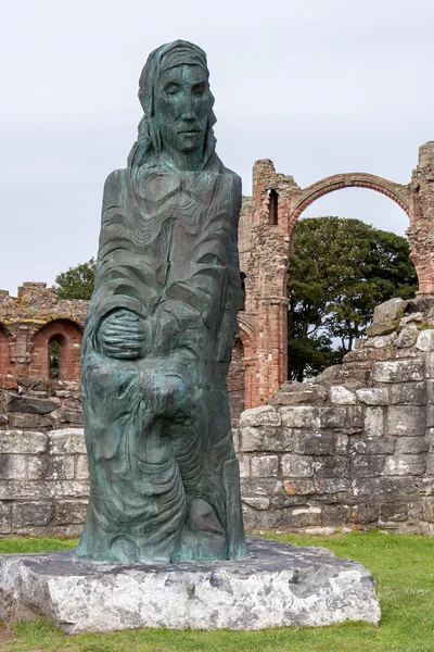 Statyn bland ruinerna av lindisfarne priory — Stockfoto