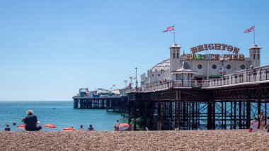 Brighton, East Sussex, UK - AUGUST 5, 2022 : View of the pier in Brighton on August 5, 2022. Unidentified people