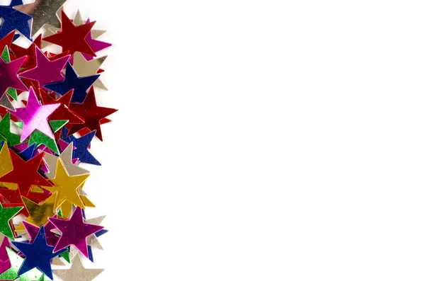 Kerstdecoratie van gekleurde confetti sterren — Stockfoto