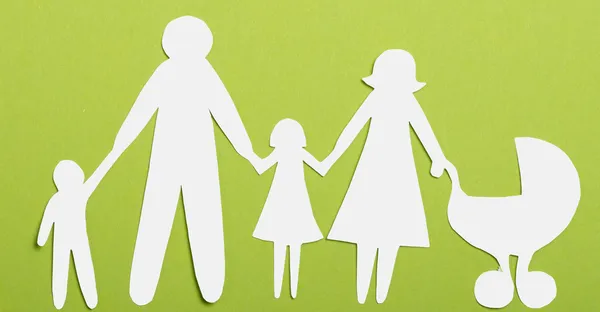 Closeup of paper family on green background — Stock Photo, Image