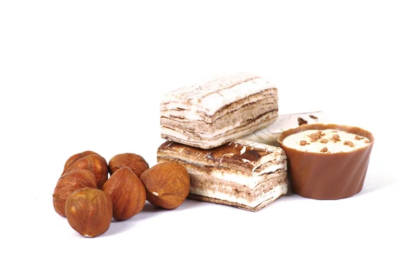 Chocolate and nuts over white — Stock Photo, Image