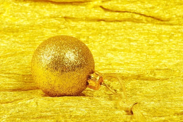 Christmas ball on golden background — Stock Photo, Image