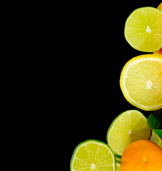 Stacks of sliced fruit isolated on black — Stockfoto