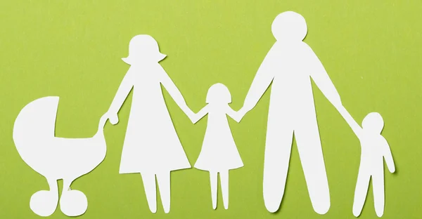 Closeup of paper family on green background — Stock Photo, Image