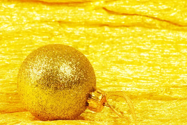 Christmas ball on golden background — Stock Photo, Image