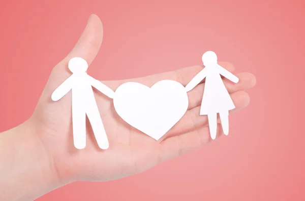Paper family in hands isolated on pink — Stock Photo, Image