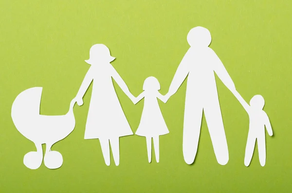 Closeup of paper family on green background — Stock Photo, Image