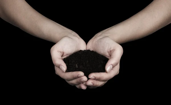 Tierra marrón y mano humana (en la mano ) — Foto de Stock