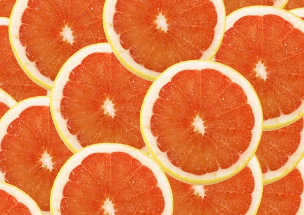 Fresh grapefruit and slices background — Stock Photo, Image