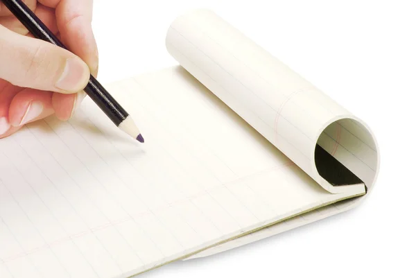 Lápis na mão escrevendo no caderno — Fotografia de Stock