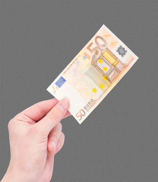 Dinero (euros) en una mano aislada sobre negro — Foto de Stock