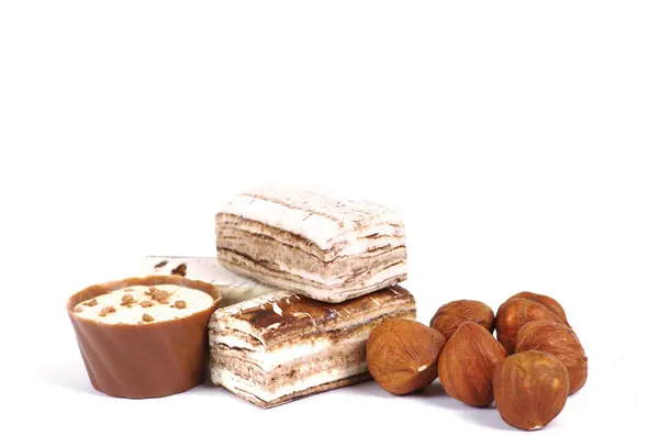 Chocolate and nuts over white — Stock Photo, Image