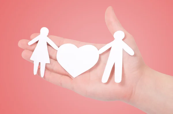 Paper family in hands isolated on pink — Stock Photo, Image