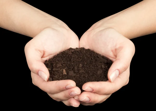 Tierra marrón y mano humana (en la mano ) — Foto de Stock