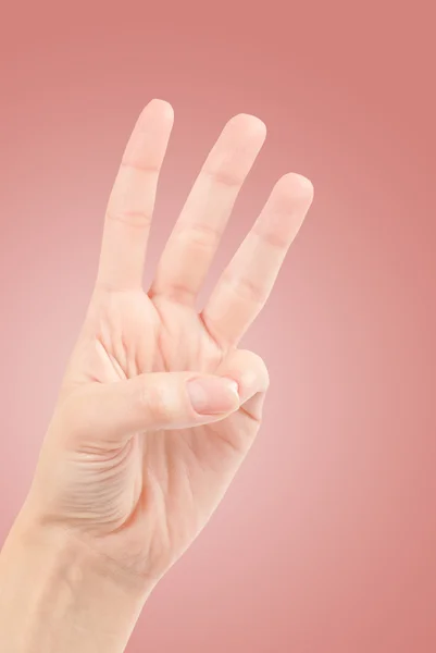 Mani femminili contando il numero tre isolato sul bianco — Foto Stock