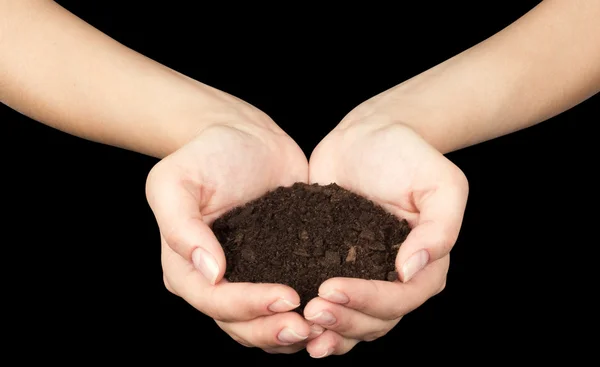 Tierra marrón y mano humana (en la mano ) — Foto de Stock