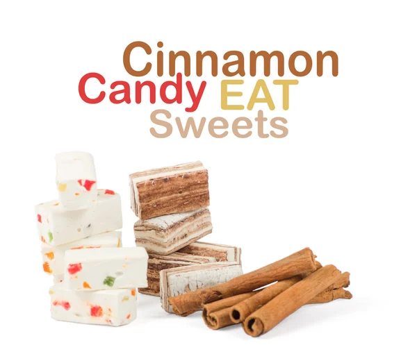 Sweets and cinnamon sticks isolated on white background — Stock Photo, Image