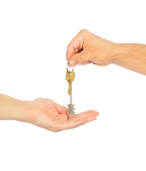 Male hand holding a car key and handing it over to another perso — Stock Photo, Image