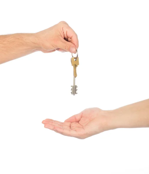 Male hand holding a car key and handing it over to another perso — Stock Photo, Image