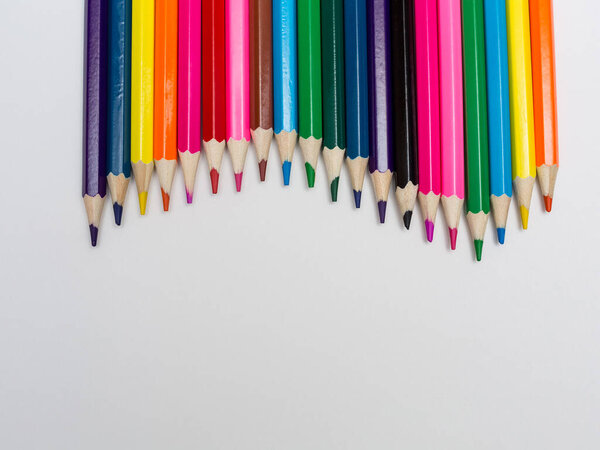 Different color pencils on white background. Painting supplies.