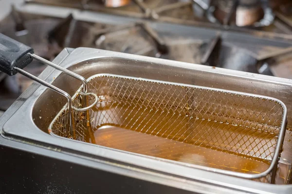 Fryer with oil for frying. Kitchen in the restaurant.