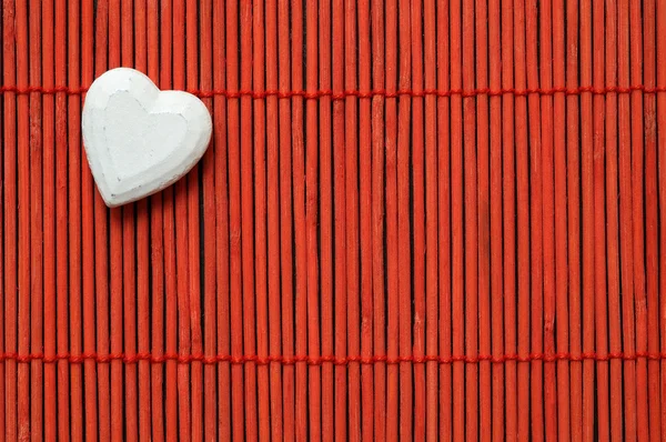 Heart on red bamboo top left corner — Stock Photo, Image