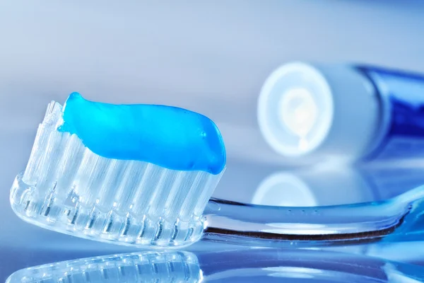 Toothbrush and toothpaste tube on the table — Stock Photo, Image
