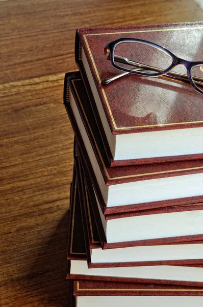 Stack of books and glasses on tablel horizontal image — Stock Photo, Image